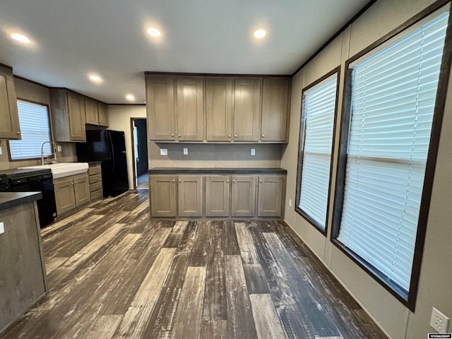 kitchen featuring sink, gray cabinets, dark wood-type flooring, and black appliances