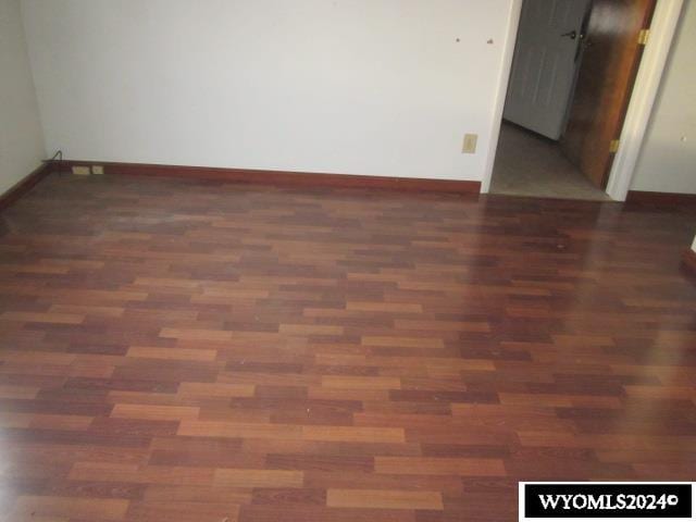 empty room featuring dark hardwood / wood-style flooring