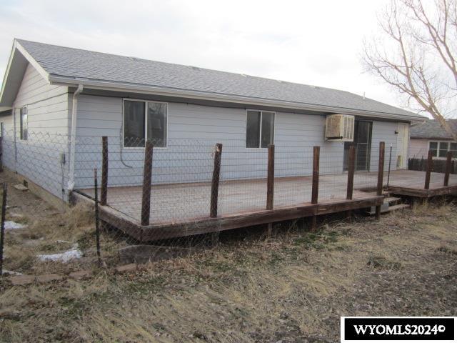 back of property featuring a wooden deck