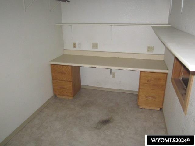 unfurnished office featuring built in desk