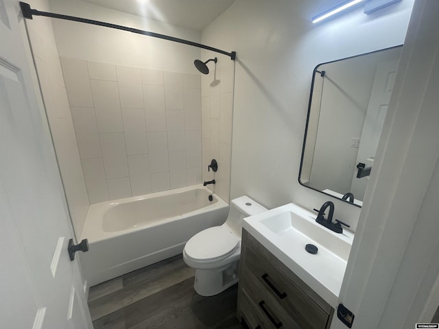 full bathroom featuring vanity, hardwood / wood-style flooring, toilet, and tiled shower / bath