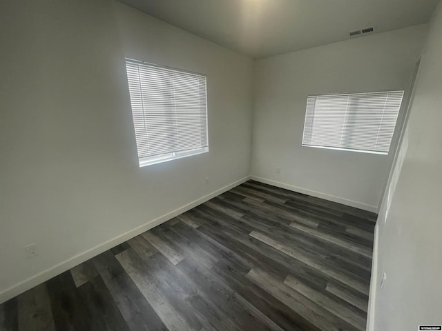 unfurnished room featuring dark hardwood / wood-style flooring