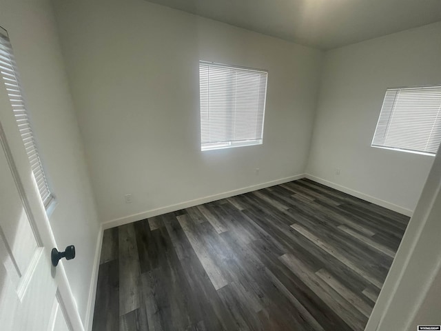 spare room featuring dark hardwood / wood-style floors