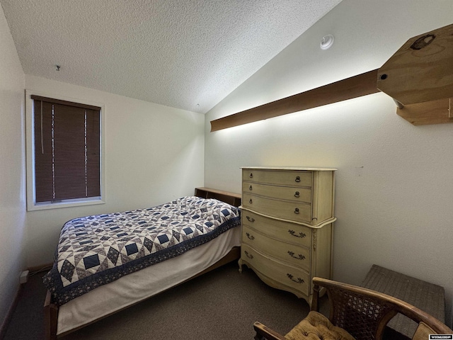 carpeted bedroom featuring a textured ceiling and vaulted ceiling