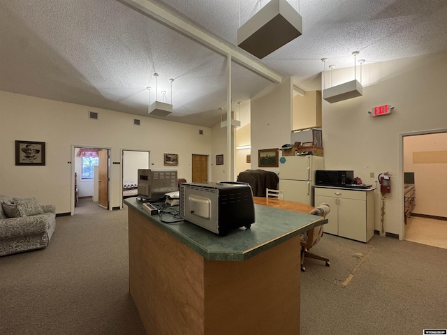 carpeted home office with a textured ceiling and high vaulted ceiling