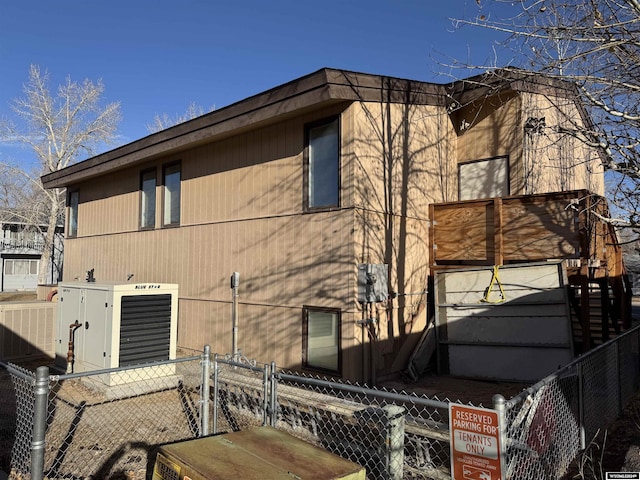 view of side of property with central air condition unit