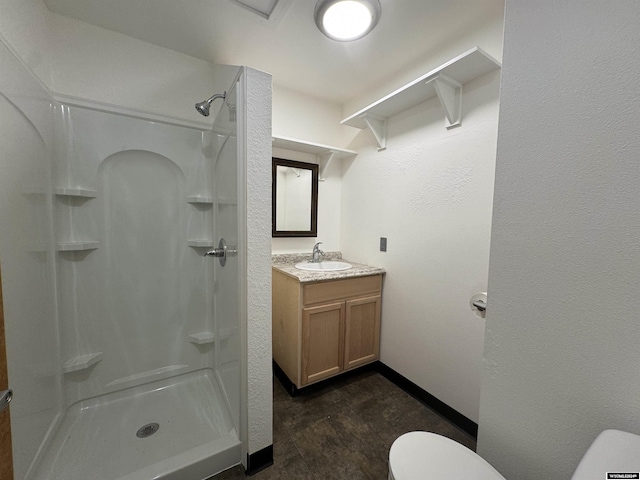 bathroom with a shower, vanity, and toilet