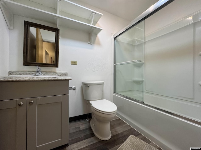 full bathroom featuring enclosed tub / shower combo, vanity, wood-type flooring, and toilet