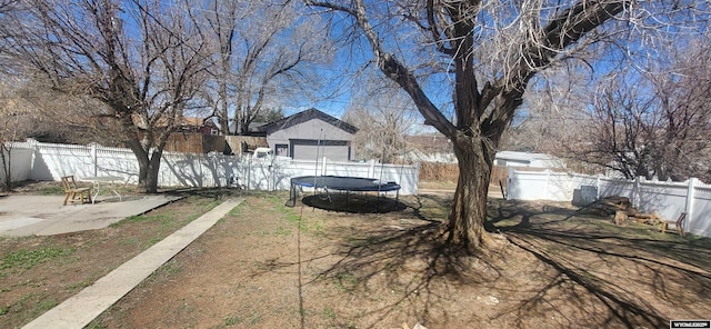 500 Madison, Rawlins, WY 82301 - view of yard featuring a fenced backyard, a trampoline, and a patio