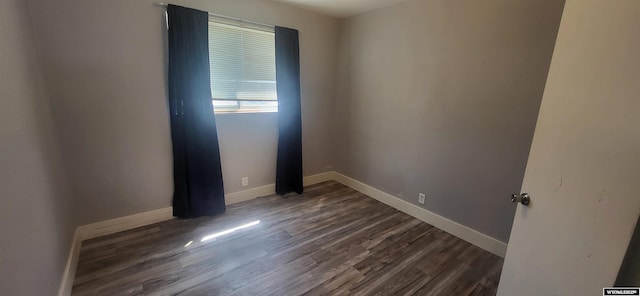 500 Madison, Rawlins, WY 82301 - unfurnished room with baseboards and dark wood-style floors