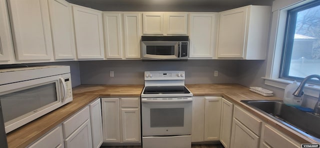 500 Madison, Rawlins, WY 82301 - kitchen with a sink, white cabinets, wooden counters, and white appliances