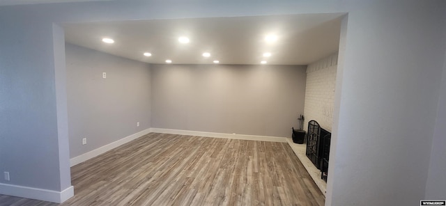 500 Madison, Rawlins, WY 82301 - unfurnished living room featuring baseboards, recessed lighting, wood finished floors, and a fireplace