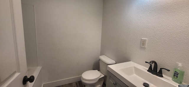 500 Madison, Rawlins, WY 82301 - bathroom with vanity, a bathing tub, toilet, and wood finished floors