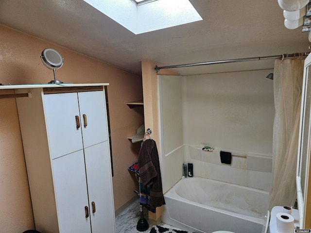 bathroom with shower / bath combo and a skylight