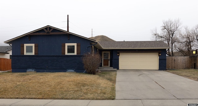 single story home featuring a front yard and a garage