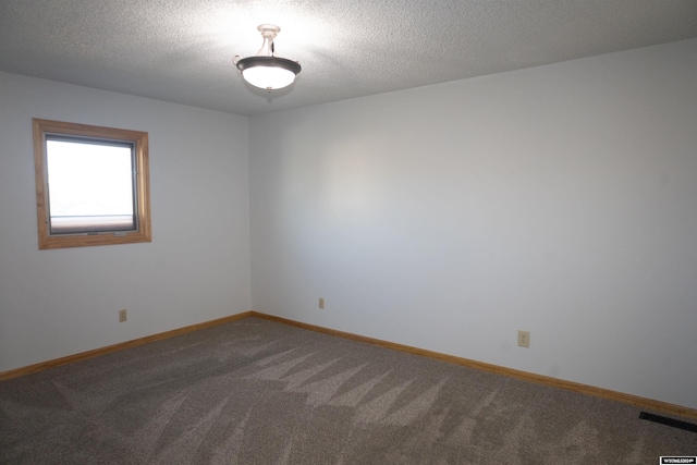 unfurnished room featuring carpet flooring and a textured ceiling