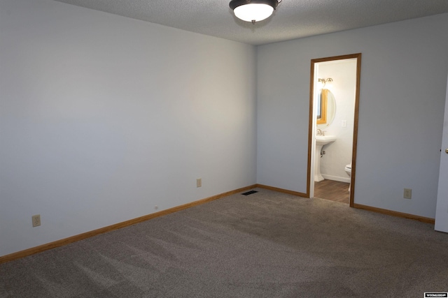 empty room featuring carpet floors and a textured ceiling