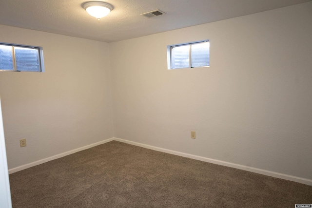 basement with dark colored carpet