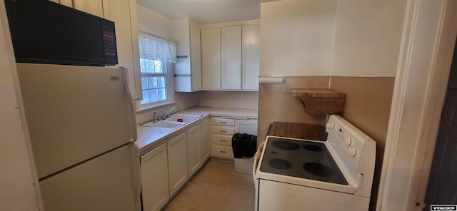 kitchen featuring sink, white cabinets, and white appliances