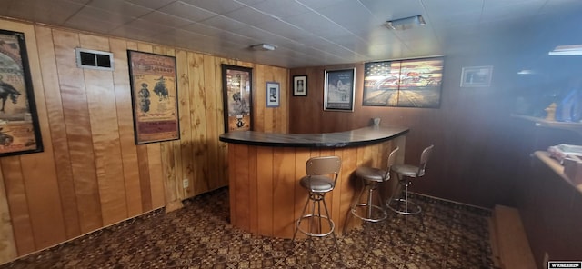 bar featuring wood walls