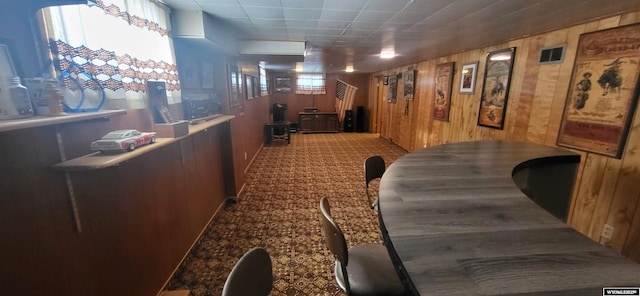 hallway with wood walls