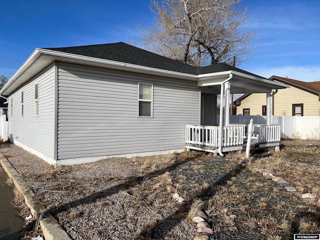 view of side of property featuring covered porch