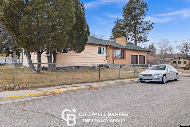 view of front of house featuring a garage and a front lawn