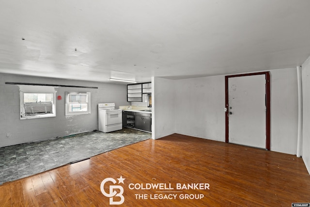 interior space featuring hardwood / wood-style flooring and concrete block wall