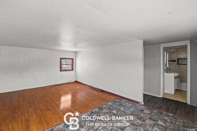 empty room featuring visible vents and wood finished floors