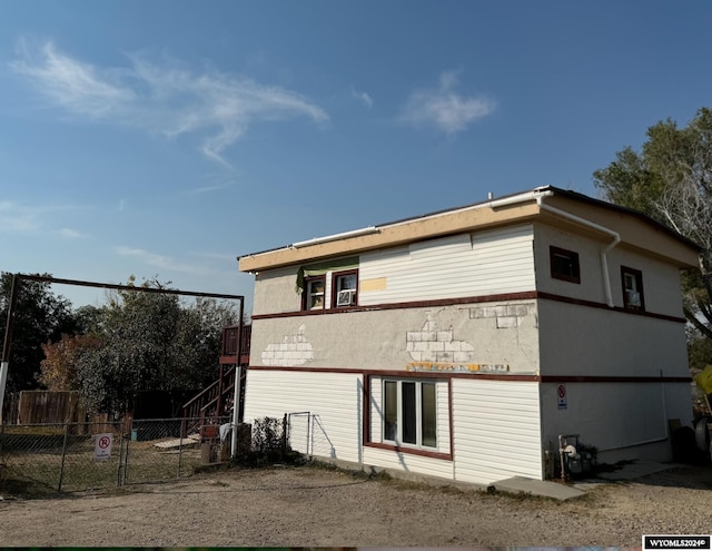 back of house with stairs and fence