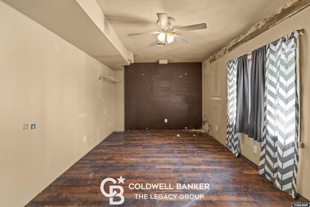 spare room with a ceiling fan and wood finished floors