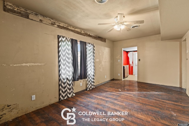 spare room featuring visible vents, wood-type flooring, and ceiling fan