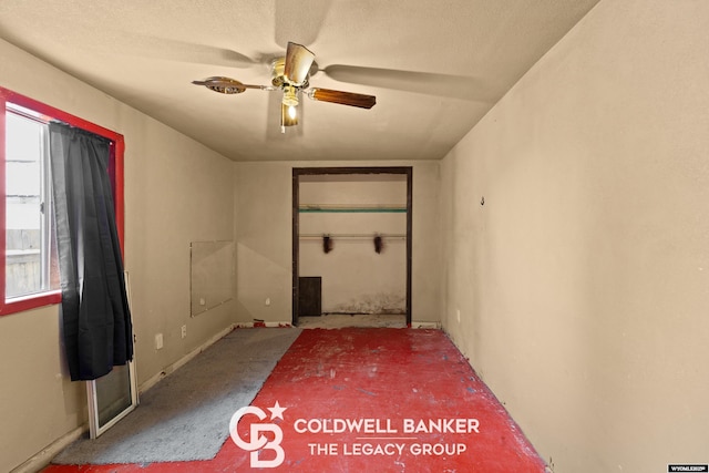 spare room with a ceiling fan and a textured ceiling