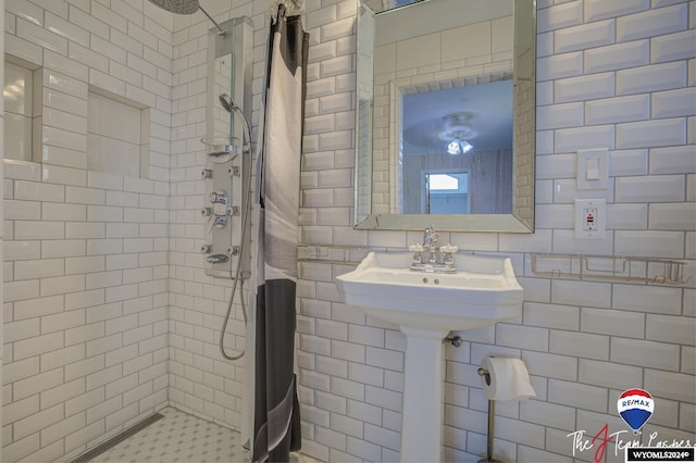 bathroom with tiled shower