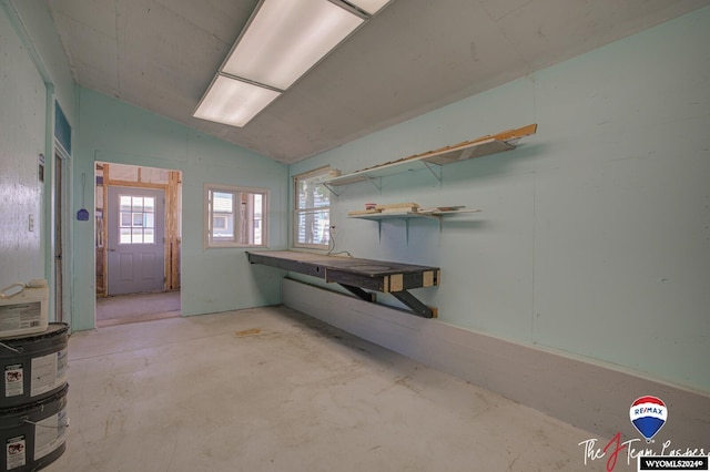 bathroom featuring concrete flooring and vaulted ceiling