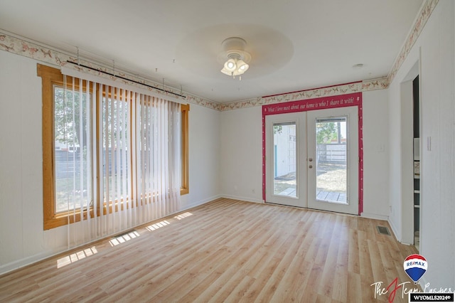 spare room featuring french doors, light hardwood / wood-style flooring, and ceiling fan