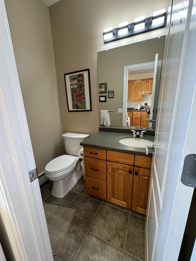 bathroom featuring vanity, toilet, and a baseboard radiator