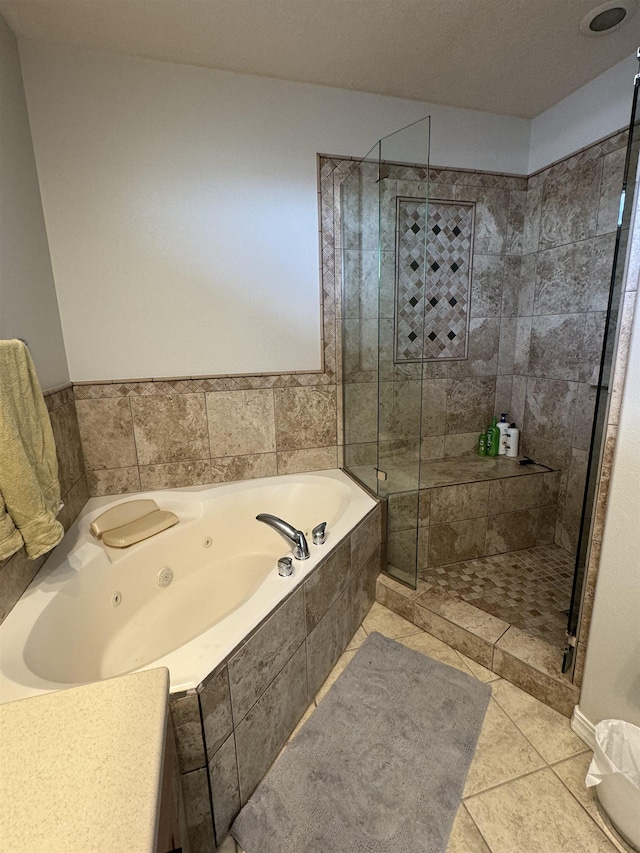 bathroom featuring tile patterned flooring and plus walk in shower