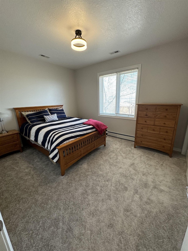 bedroom featuring a textured ceiling, light carpet, and a baseboard heating unit