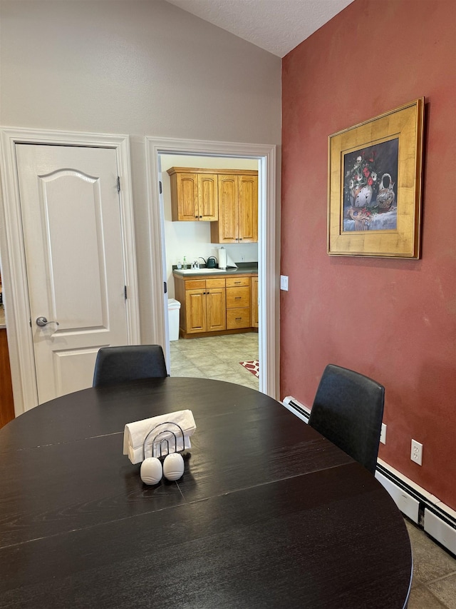 dining area featuring sink and a baseboard radiator