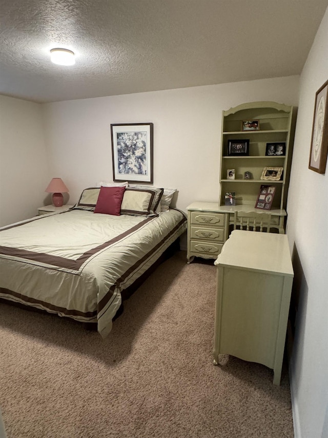 bedroom with a textured ceiling and light carpet