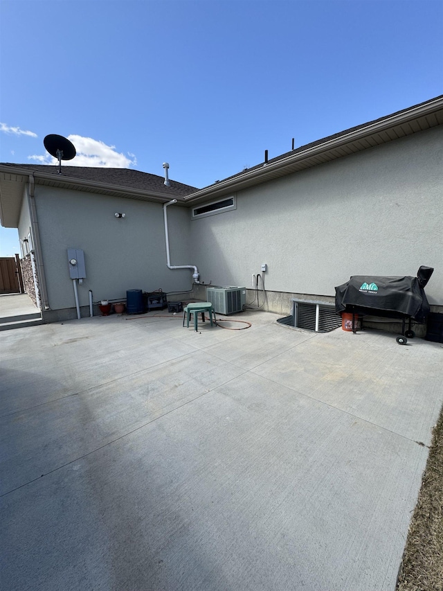 exterior space with central AC unit and a patio area