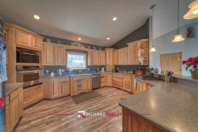 kitchen featuring light brown cabinets, vaulted ceiling, light wood-type flooring, decorative light fixtures, and stainless steel appliances