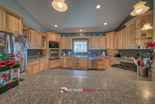 kitchen featuring pendant lighting, lofted ceiling, sink, and appliances with stainless steel finishes