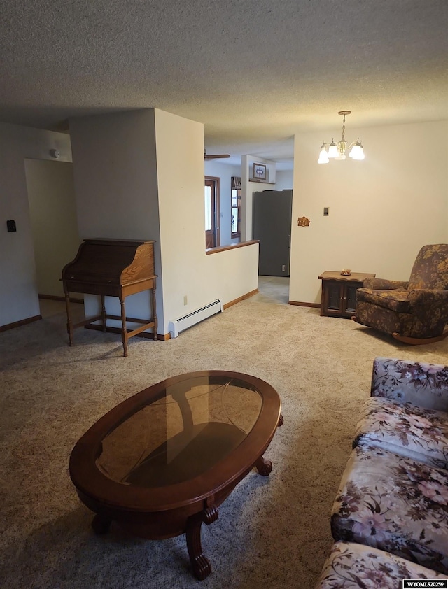 living room with baseboard heating, carpet flooring, a textured ceiling, and an inviting chandelier