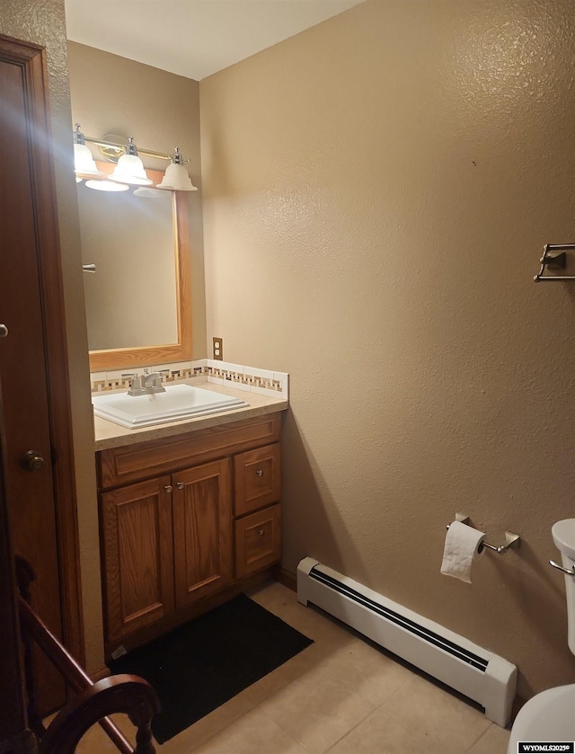 bathroom featuring tile patterned floors, vanity, and a baseboard radiator