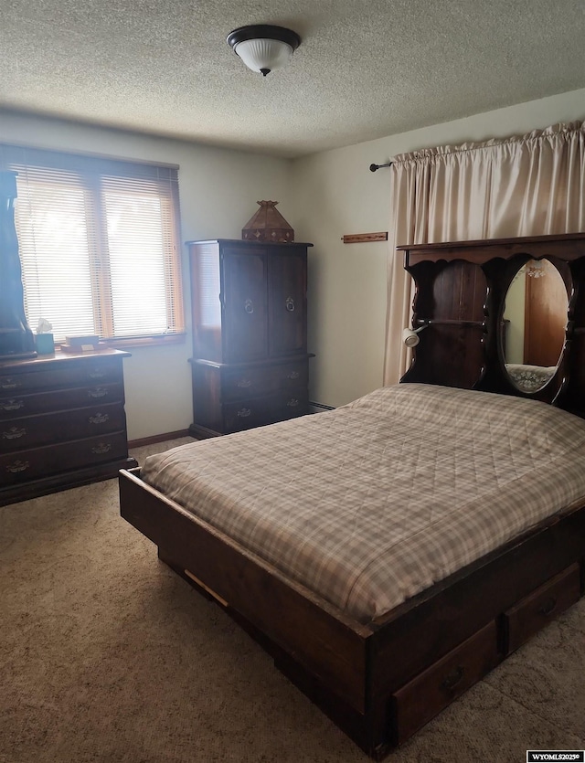 bedroom featuring carpet flooring and a textured ceiling