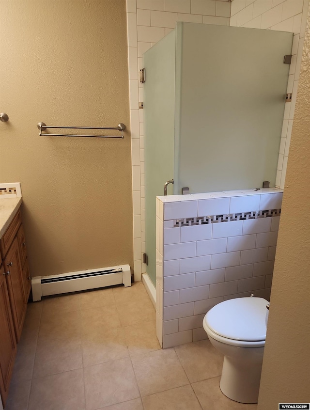 bathroom featuring vanity, tile patterned flooring, toilet, baseboard heating, and an enclosed shower