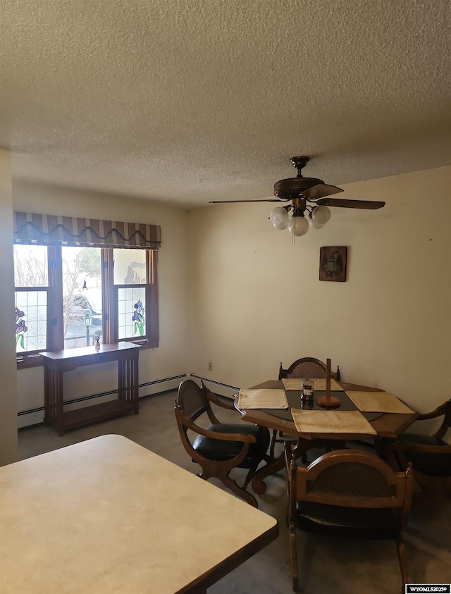 dining room featuring dark colored carpet, a textured ceiling, baseboard heating, and ceiling fan