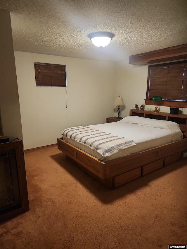 carpeted bedroom with a textured ceiling